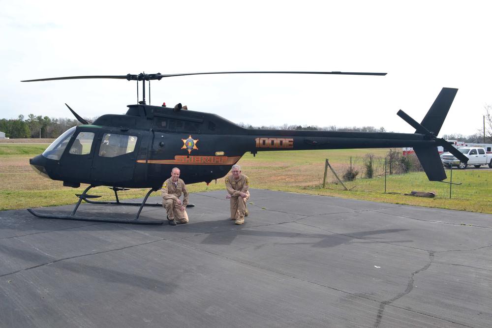 Aviation Unit kneeling in front of the helicopter for Marshall Co